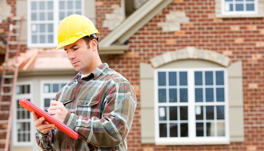 Man Inspecting House for Termites