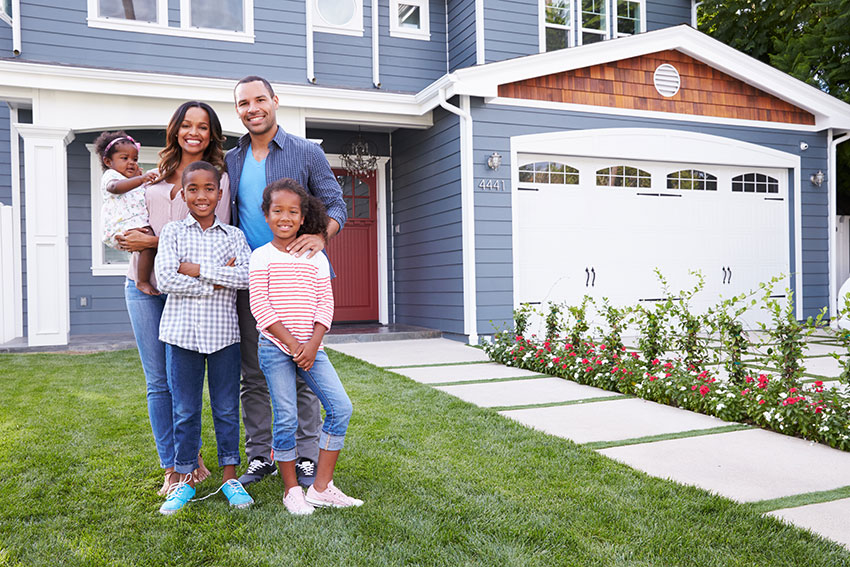 Happy Family In Front of Home Happy Family In Front of Home